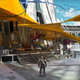 A Guardian stands nears some merchant stalls in Destiny 2's Tower.